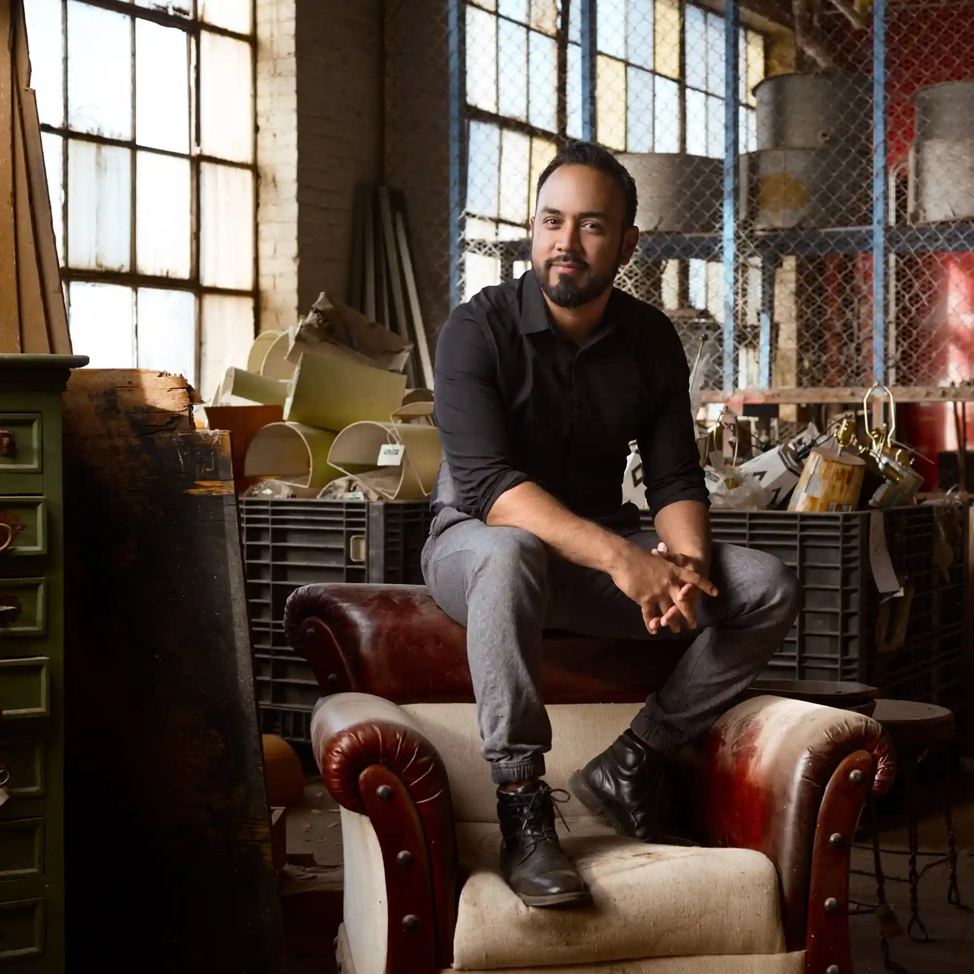 Hispanic entrepreneur portrait on red chair